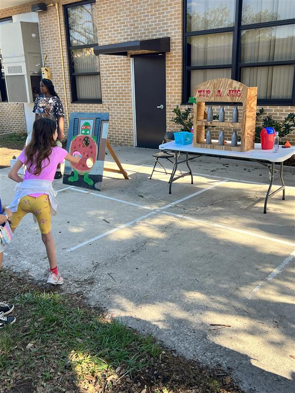 Student taking their shot at Tip-A-Jug!